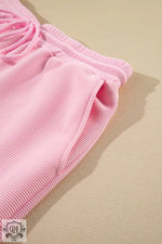 Pink corduroy drawstring shorts styled with Apricot Textured Ruffled Set for relaxed comfort