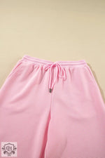 Pink ribbed drawstring pants from Apricot Textured Ruffled Sleeve Zipped Top Set