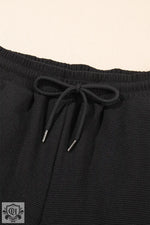 Black drawstring shorts complement Apricot Textured Ruffled Sleeve Zipped Top set