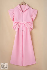 Pink two-piece outfit featuring textured ruffled sleeves and wide leg pants for relaxation