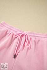 Pink corduroy shorts featured in Apricot Textured Ruffled Sleeve Zipped Top Set