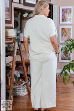 Woman in cream-colored pantsuit from Beige Plus Size Textured Collared Top and Pants Set