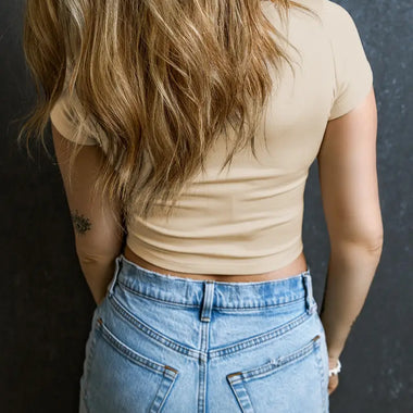 High-waisted blue denim jeans with Beige Ribbed Knit U Neck Crop Top in stylish sizes