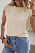 Sleeveless cream knit top with blue jeans and gold necklace for casual relax looks