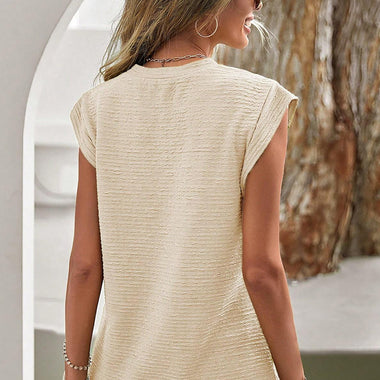 Sleeveless beige textured top with crew neckline for relaxed style in various sizes