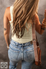 Woman in light-wash denim jeans paired with a Black Floral Jacquard Square Neck Tank Top