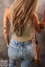 Back view of light blue jeans and beige tank top with brown leather strap, sizes bust waist