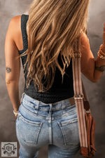 Back view of a person in a black tank top showing tattoos, highlighting bust waist fit