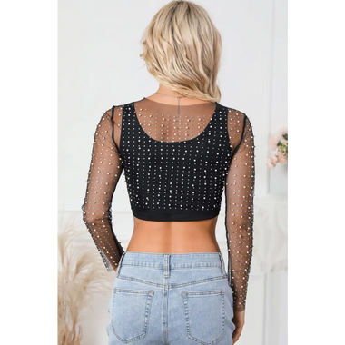 Black mesh long-sleeved crop top with rhinestone details paired with denim jeans in sizes bust sleeve