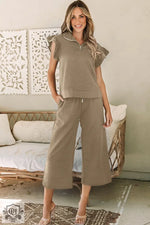 Woman’s olive-green two-piece outfit, featuring Black Textured Flutter Sleeve Top and wide leg pants