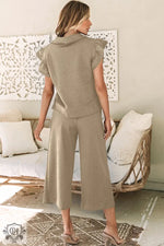 Woman’s khaki-colored two-piece outfit featuring a flutter sleeve top and wide leg pants