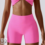 Bright pink athletic shorts featuring a block colour high waist design for yoga