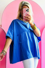 Bright blue oversized t-shirt with short sleeves and stylish exposed seams in various sizes