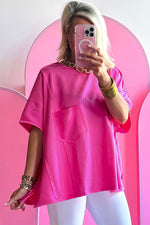 Hot pink oversized t-shirt with chest pocket, perfect for relaxed styles in all sizes