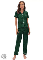 Woman wearing a green satin buttoned short sleeve lounge set