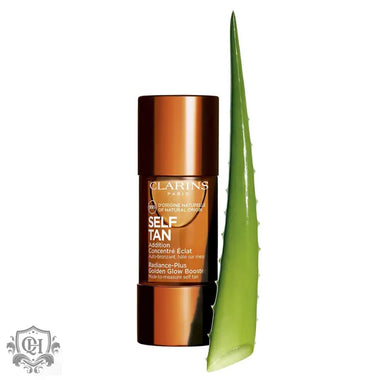 Bronze Clarins Radiance-Plus Golden Glow Booster next to fresh aloe vera leaf