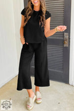 Black textured knit two-piece outfit featuring a cap sleeve T-shirt and wide leg pants