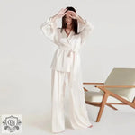 Woman wearing an Elegant Tie Up Silk Pajama Set in luxurious white silk