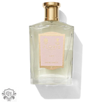 Clear glass perfume bottle with gold cap and pink label for Floris Lily Eau de Toilette