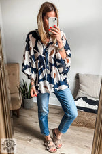 Floral Print Puff Sleeve Blouse in Navy and Peach Tones with Blue Jeans and Sandals