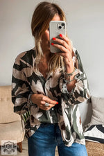 Flowy camo-print blouse in Euro sizes paired with blue jeans for a relaxed look