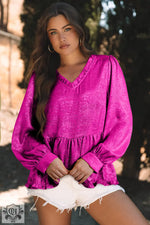 Bright fuchsia blouse with puff sleeves, ruffled neckline, and gold metallic frilled details