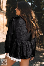 Black textured peplum blouse with long sleeves and gathered waist for a gold metallic frilled look