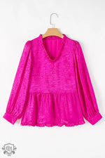 Bright pink peplum blouse with long sleeves in textured fabric for relaxed style