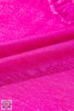 Bright pink satin fabric with subtle folds, highlighting Gold Metallic Frilled design