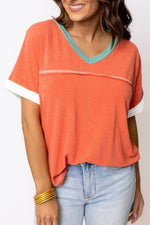 Coral V-neck T-shirt with turquoise trim and white accents for relax relax styles