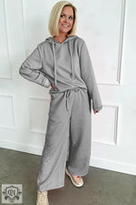 Gray quilted lounge set featuring a drawstring hoodie and wide leg pants for ultimate relaxation