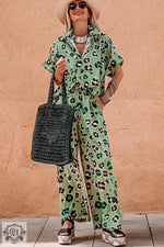 Woman wearing a stylish green leopard print short sleeve shirt and wide leg pants set