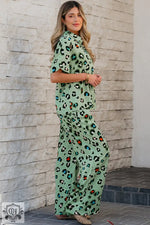 Woman in green leopard print short sleeve shirt and wide leg pants set