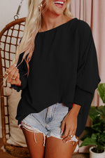 Black oversized knit sweater with distressed denim shorts for a relaxed style