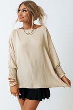 Cream-colored sweater with smocked cuffs and relaxed fit, available in various Euro sizes