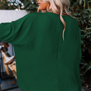 Emerald green oversized sweater with long sleeves from the Green Smocked Wrist Shift Top