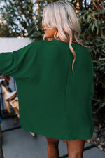 Emerald green oversized sweater with long sleeves from the Green Smocked Wrist Shift Top