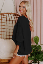 Black balloon-sleeve sweater with relaxed fit available in various euro sizes