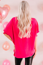 Hot pink oversized t-shirt with short sleeves styled with black leather pants in Euro sizes