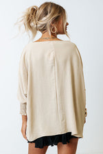 Loose-fitting beige sweater over a black skirt, available in Euro sizes for relaxed style