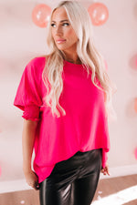 Hot pink ruffle-sleeved top with black leather pants from Green Smocked Wrist Shift Top