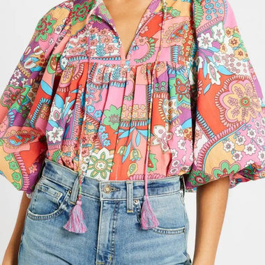 Colorful paisley-print blouse with puff sleeves and tassels, perfect for relaxed outfits