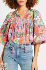 Colorful paisley-print blouse with puff sleeves and tassels, perfect for relaxed outfits