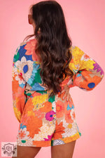 Colorful floral romper with long sleeves on vibrant orange base, in Euro sizes