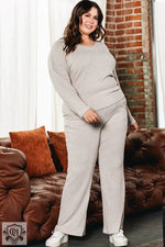 Woman modeling Parchment Plus Size Ribbed V Neck Pullover and Pants Set for ultimate relaxation