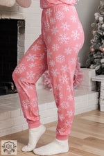 Pink pajama pants with snowflake print for cozy relaxation in festive loungewear