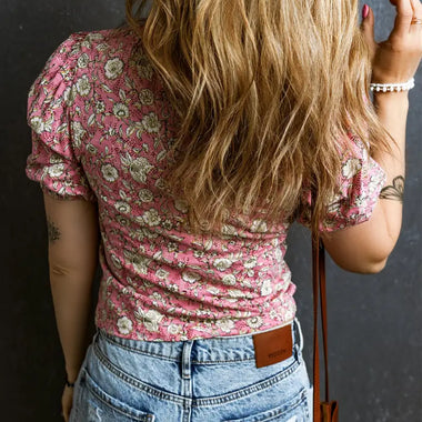 Back view of model in Pink Floral Short Puff Sleeve V Neck Ruched Blouse and light jeans