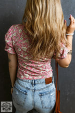 Back view of model in Pink Floral Short Puff Sleeve V Neck Ruched Blouse and light jeans