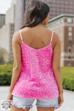 Hot pink sequined camisole top with thin straps in adjustable sizes for a relaxed fit