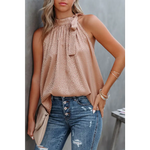 Sleeveless blush polka dot blouse with tie neck detail, perfect for relaxed styles